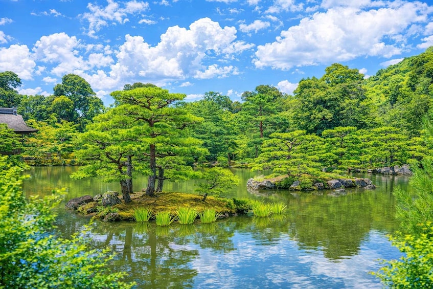 A serene Japanese garden with a pond, lush greenery, and a traditional building. 4