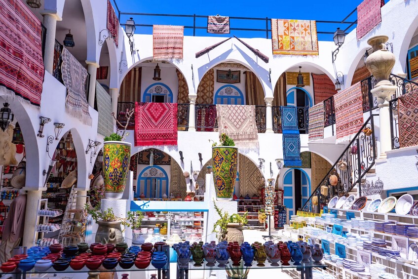 A vibrant market with colorful textiles and pottery. 1