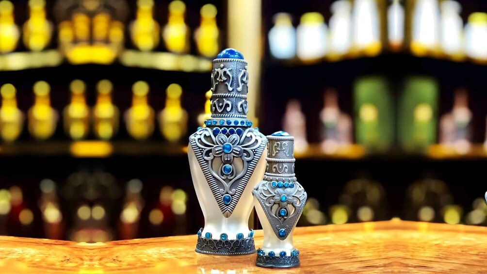 Two ornate vases with blue and white patterns on a wooden surface, with a blurred bar in the background. 5