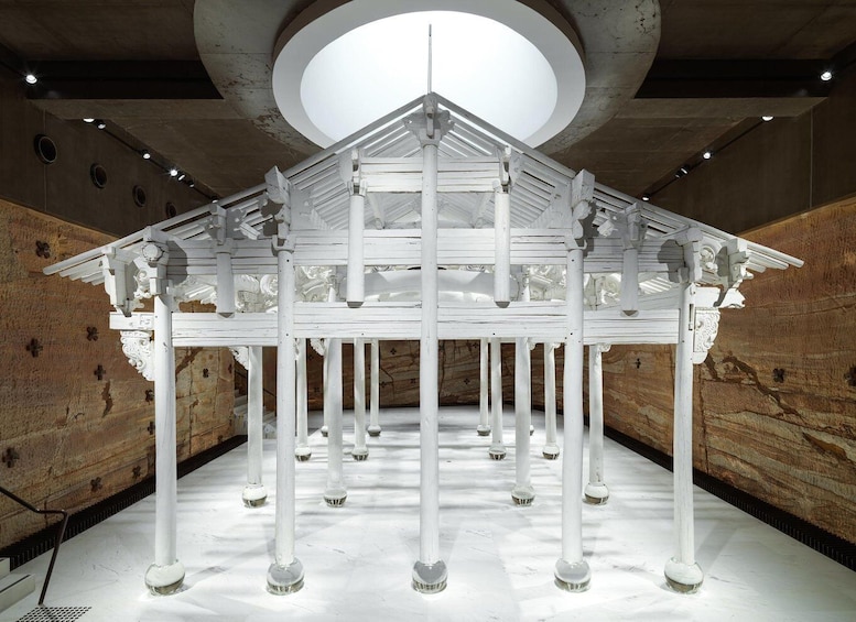 A white architectural structure with a central dome and multiple columns. 3
