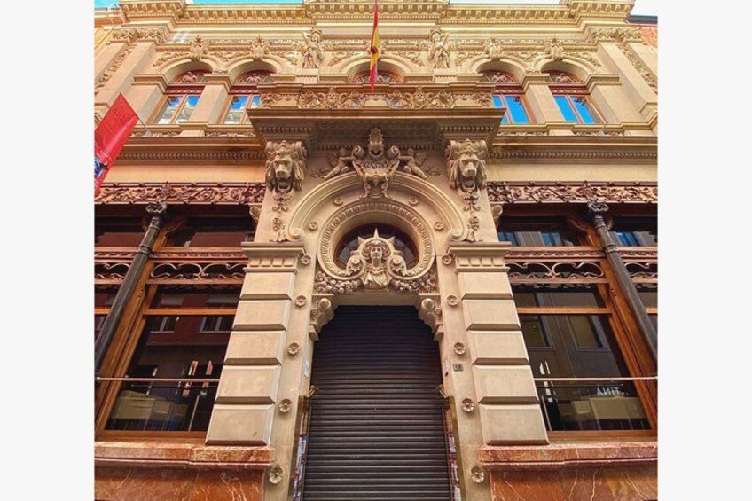 An ornate building facade with intricate carvings and a large arched entrance. 2