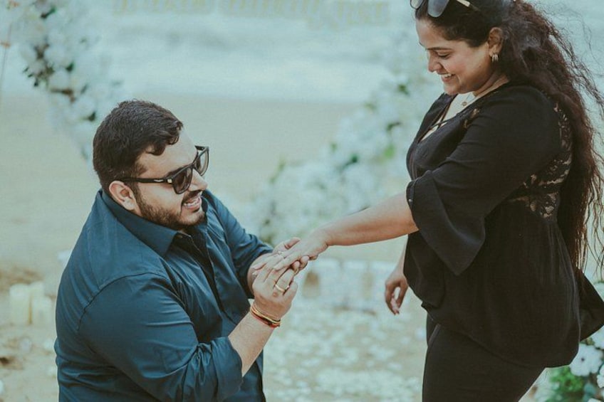 A person wearing a dark shirt and sunglasses, holding hands with another person in a black outfit. 1