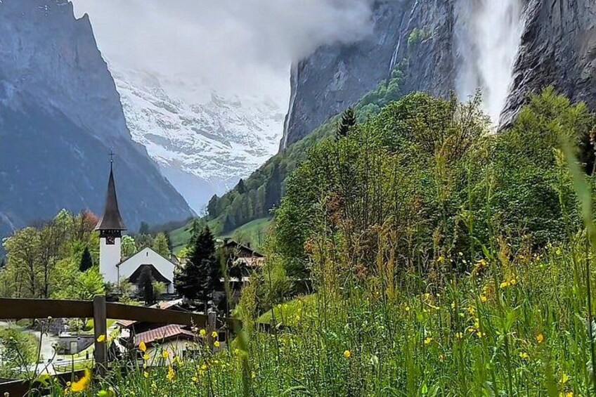 A church, a waterfall, and a mountainous landscape. 3