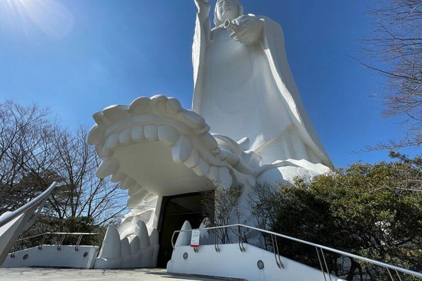 A large white statue with a unique shell-like structure at its base. 2