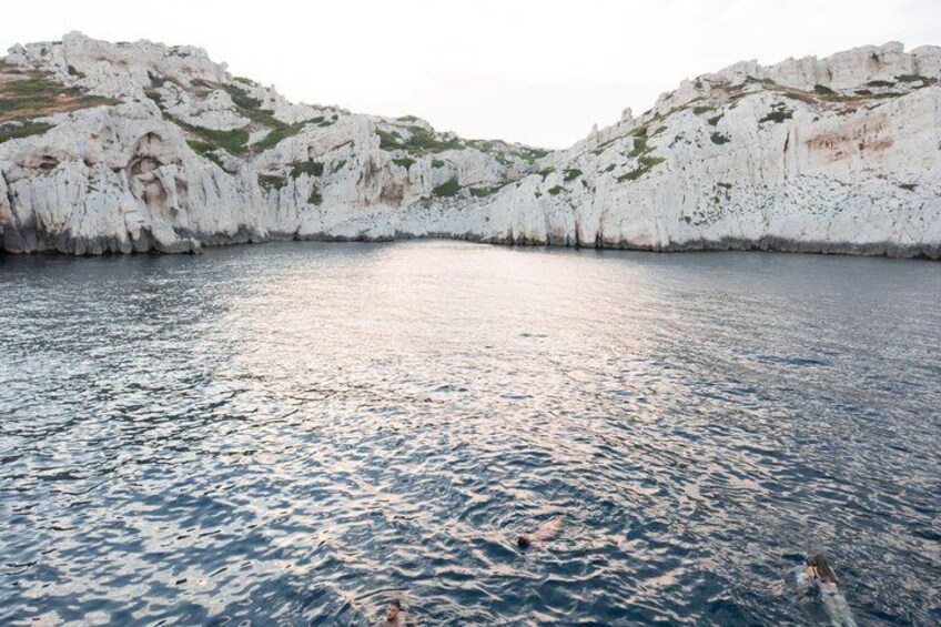 A coastal landscape with white cliffs and calm sea. 5