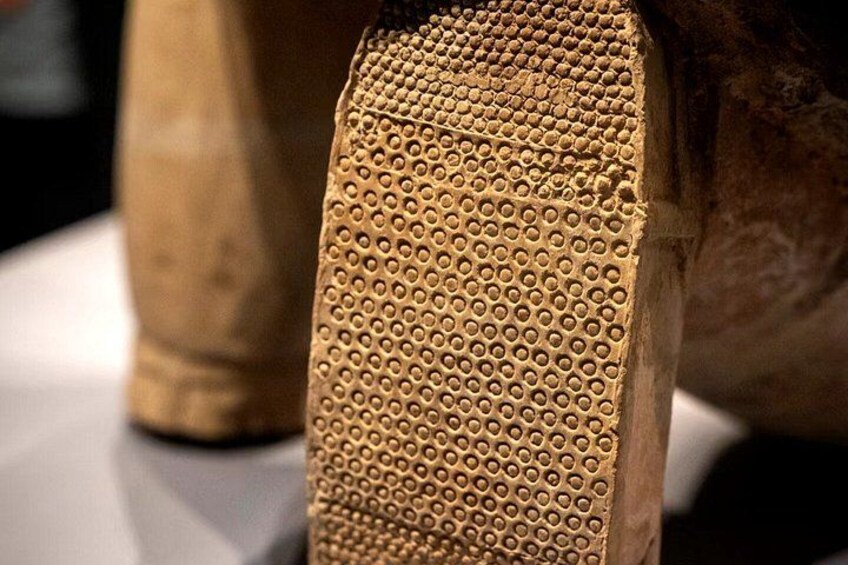 A close-up of a textured surface with a pattern of circular indentations. 4