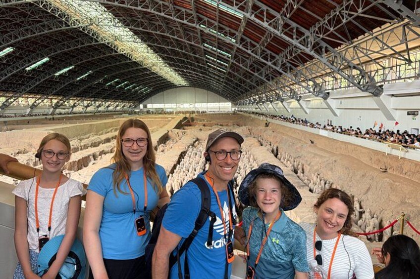 An indoor archaeological site with visitors. 1