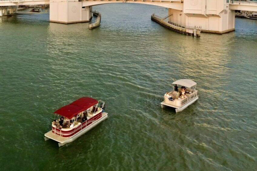 Two boats on a river with a bridge in the background. 5