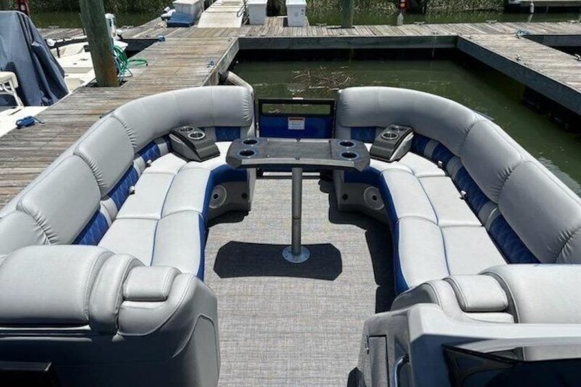 A boat with a central table and seating. 2