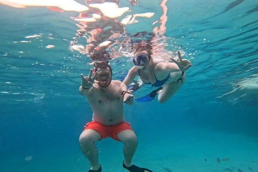 Two people snorkeling underwater. 3