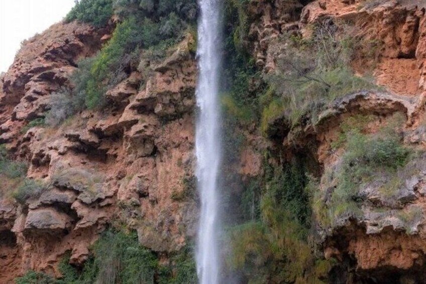 A waterfall cascading down a rocky cliff. 4