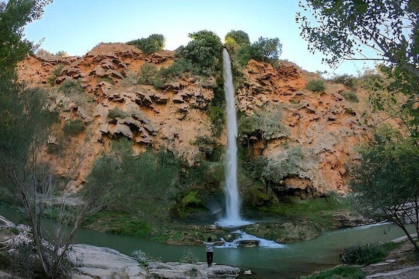 A waterfall, rocky cliffs, and a river. 2