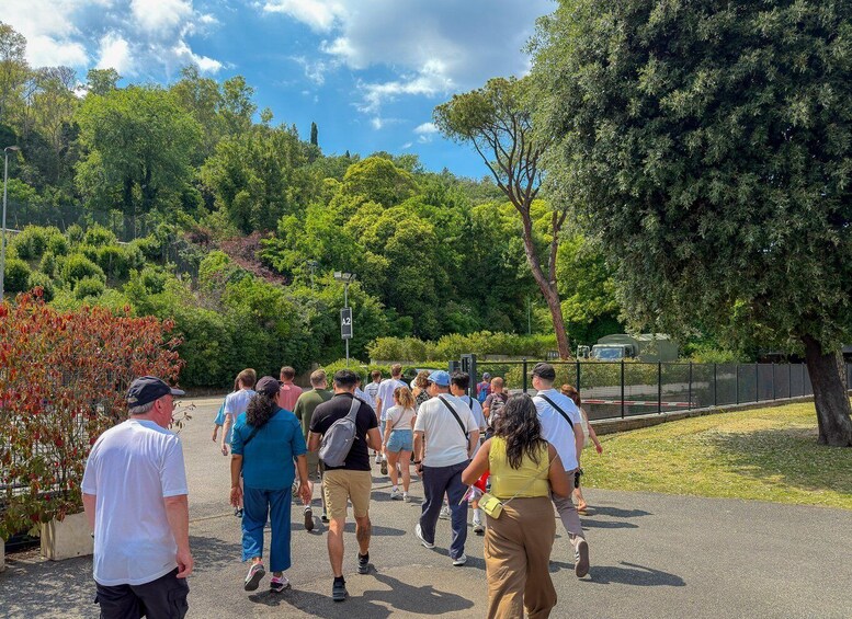 A group of people walking on a path surrounded by trees and greenery. 5