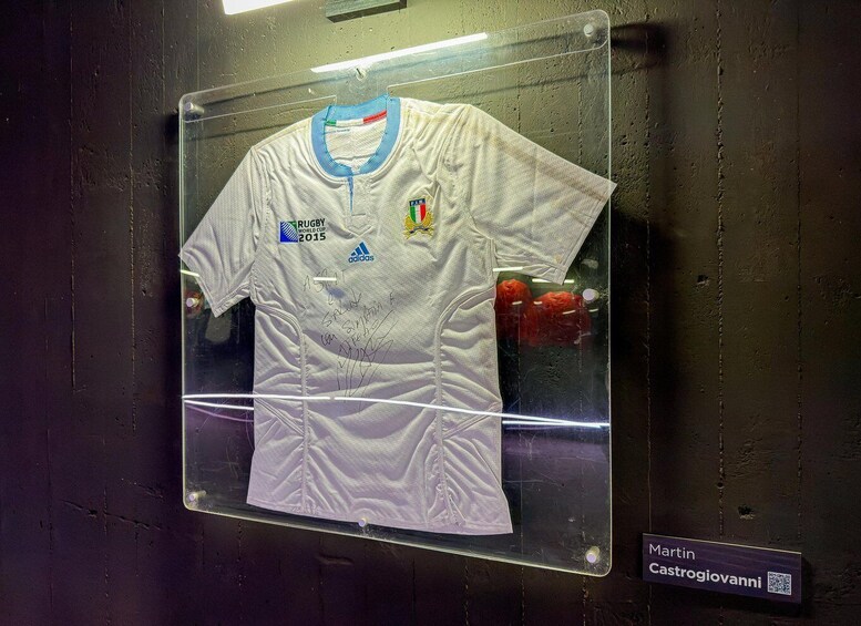 A signed rugby jersey displayed in a glass case. 2