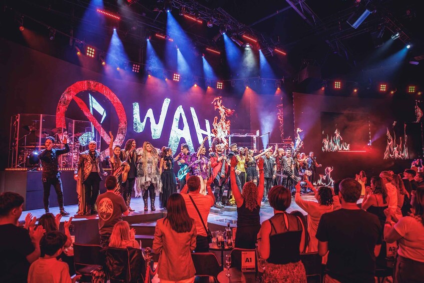 A live concert with a stage, audience, and performers. 4