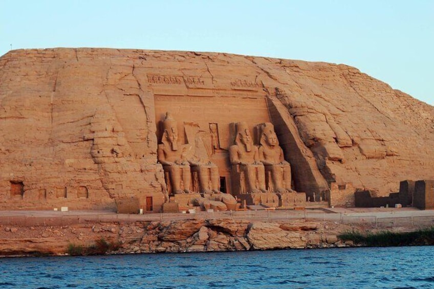 A large rock-cut temple with hieroglyphs and statues. 2