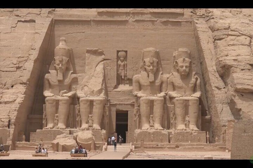 A large ancient Egyptian temple with colossal statues of pharaohs. 4