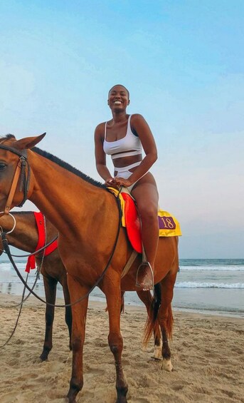 A person riding a horse on a beach. 2