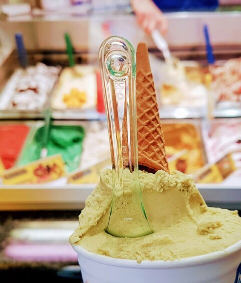 A waffle cone with a scoop of ice cream in a cup. 2