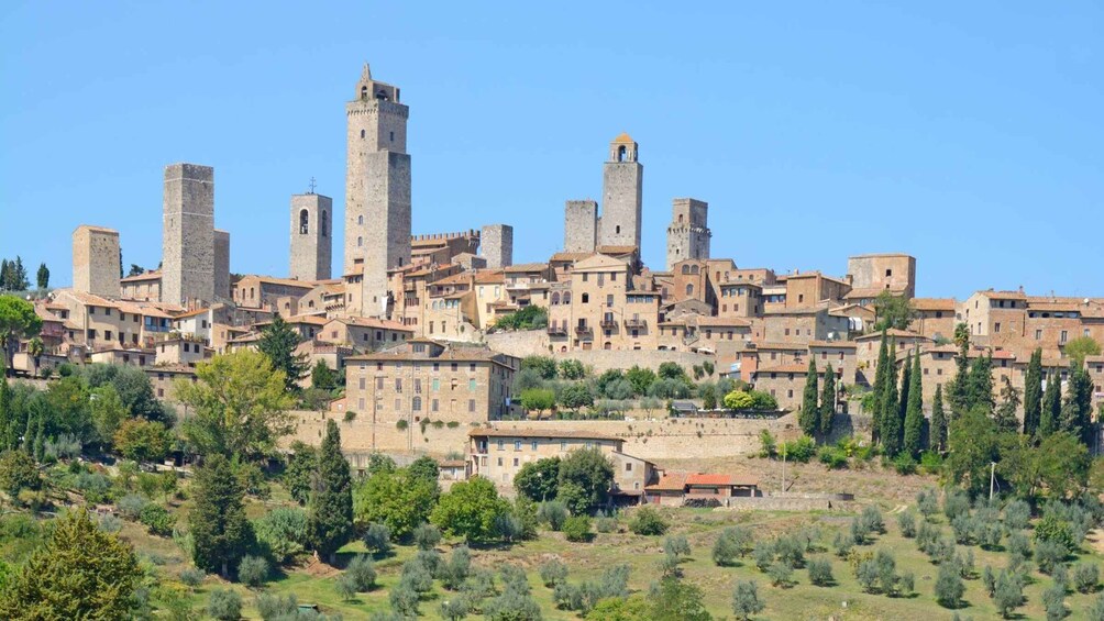 A historic town with medieval towers and buildings. 5