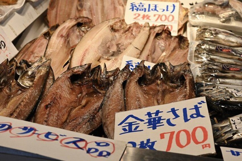 A variety of fish displayed for sale at a market, with price tags visible. 3