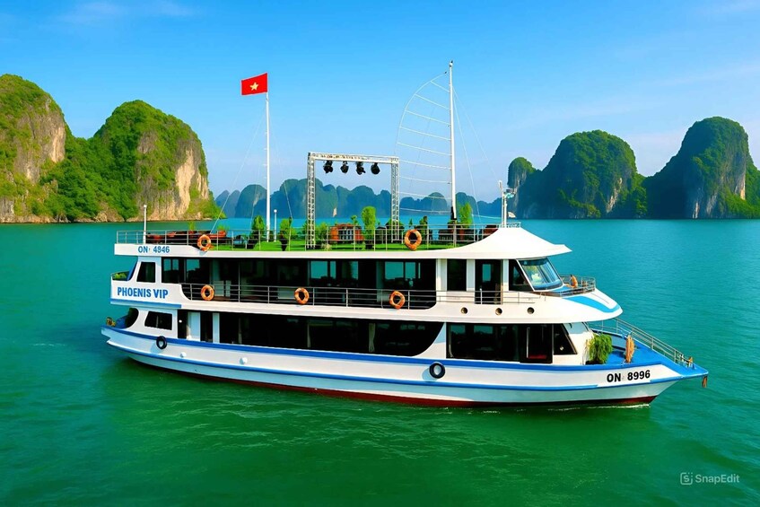 A boat named 'PHOENIS VIP' with the registration number 'ON 8996' on a calm body of water surrounded by green cliffs. 2