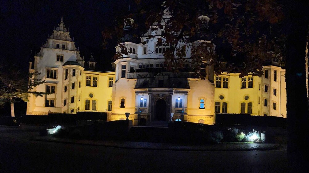 A large, illuminated castle-like building at night. 2