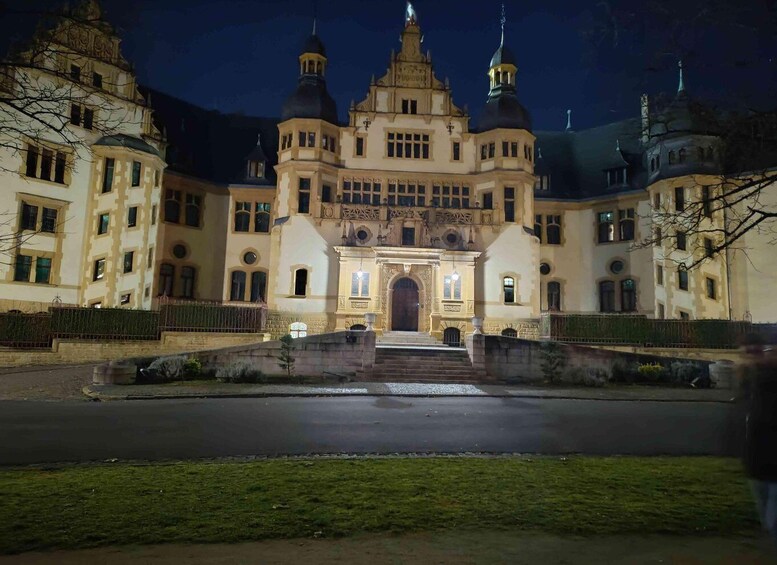 A large, ornate building with multiple towers and a central entrance. 1