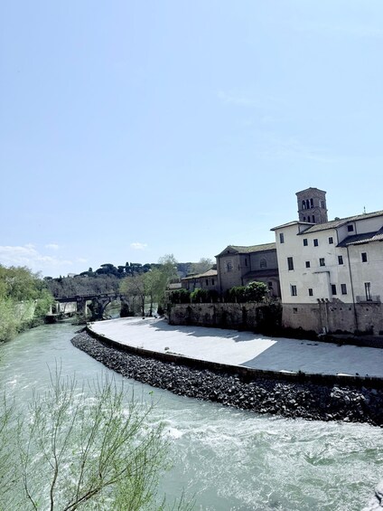 A river flowing through a town with a bridge and historic buildings. 5