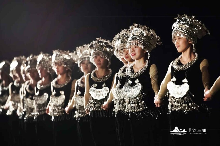 A group of individuals in traditional attire with elaborate headpieces and jewelry. 4