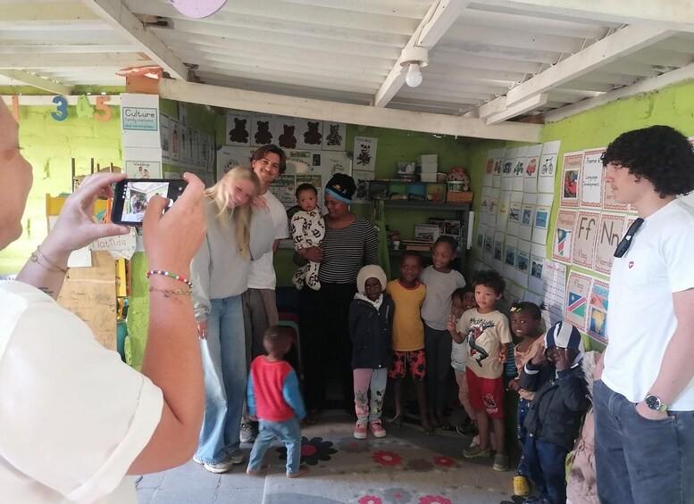 A group of people in a room with educational posters on the walls. 5