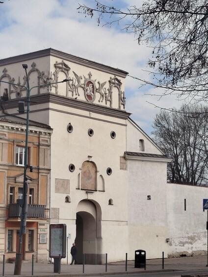 A historic building with ornate sculptures and a central archway. 5