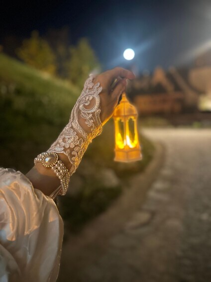 A person holding a lantern at night. 2