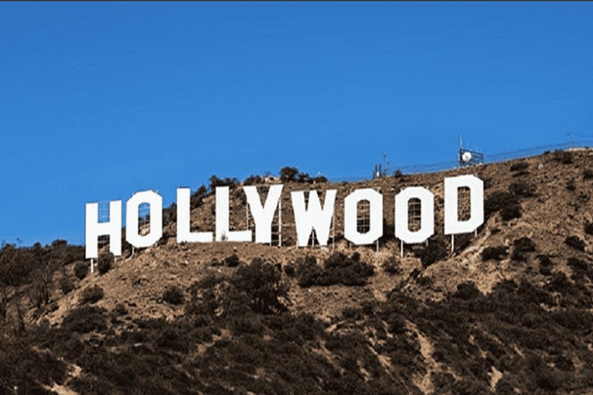 The Hollywood sign on a hill with a clear blue sky. 1