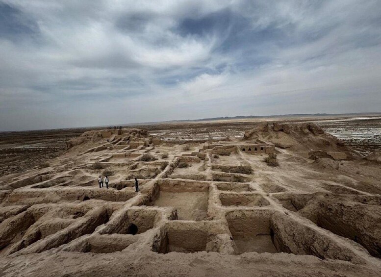 Ancient ruins with rectangular structures and a desert landscape. 2