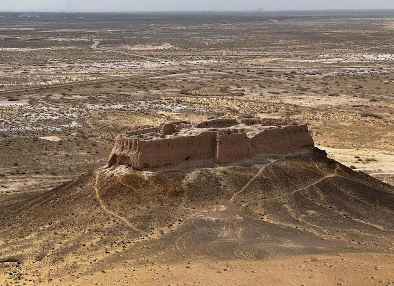 A large, ancient ruin in a desert landscape. 3