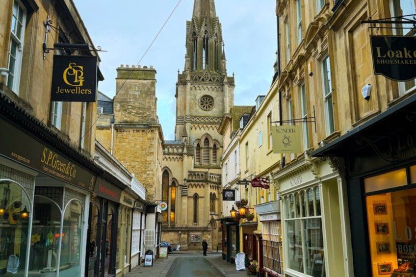 A street with shops and a historic building in the background. 5