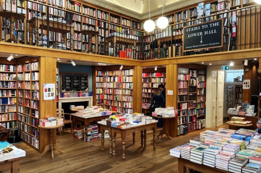 A large, well-stocked bookstore with multiple shelves and tables displaying books. 3