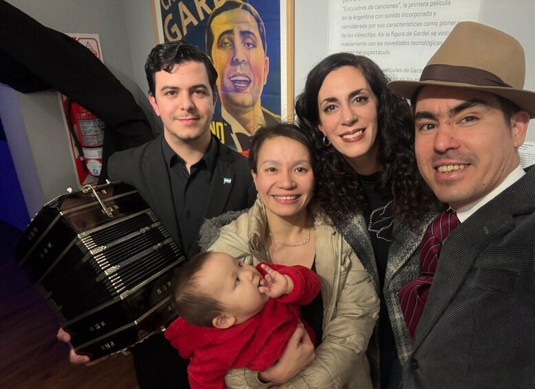 A group of people with a vintage accordion, a poster, and a fire extinguisher. 4