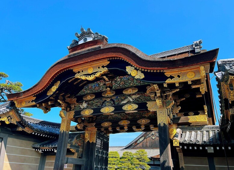 A traditional Japanese gate with ornate golden decorations and a curved roof. 1
