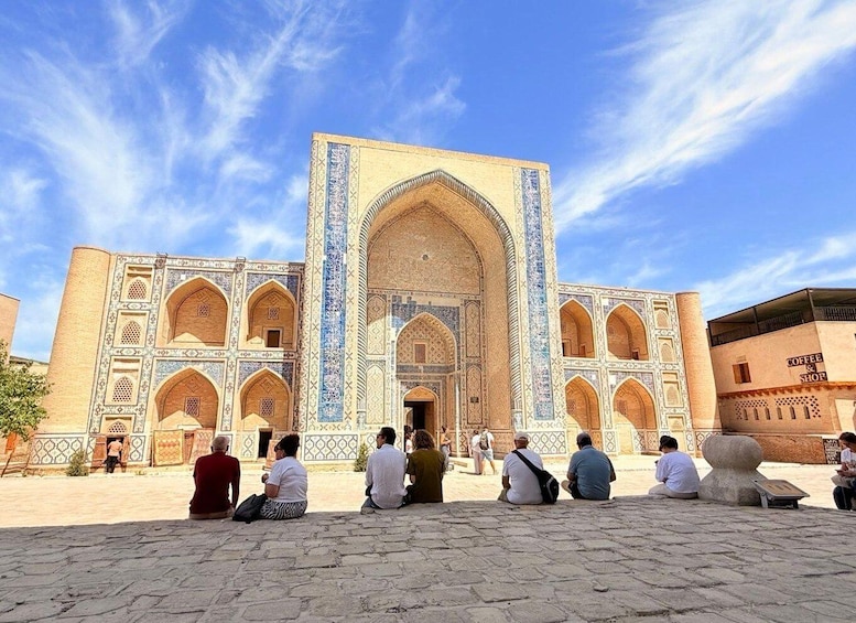 A historic building with intricate tile work and arched doorways. 1