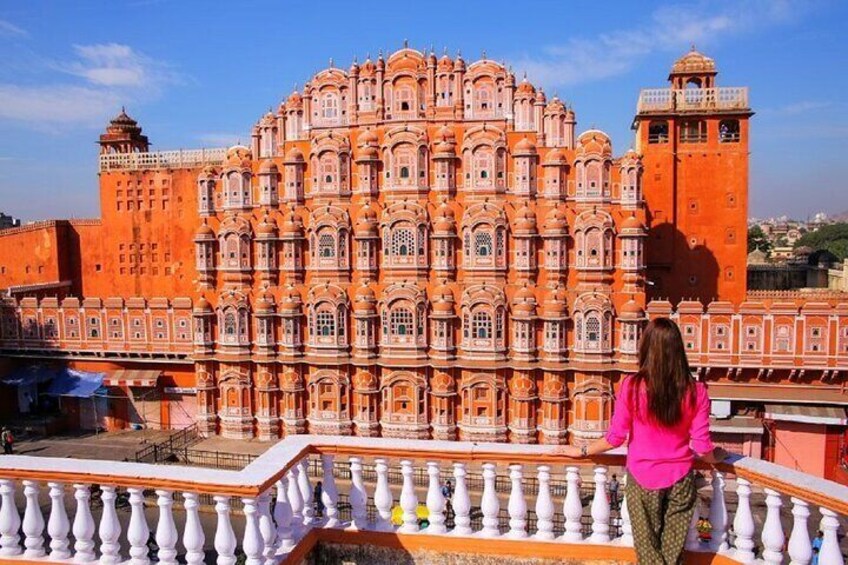 A large, ornate building with multiple windows and a balcony. 1