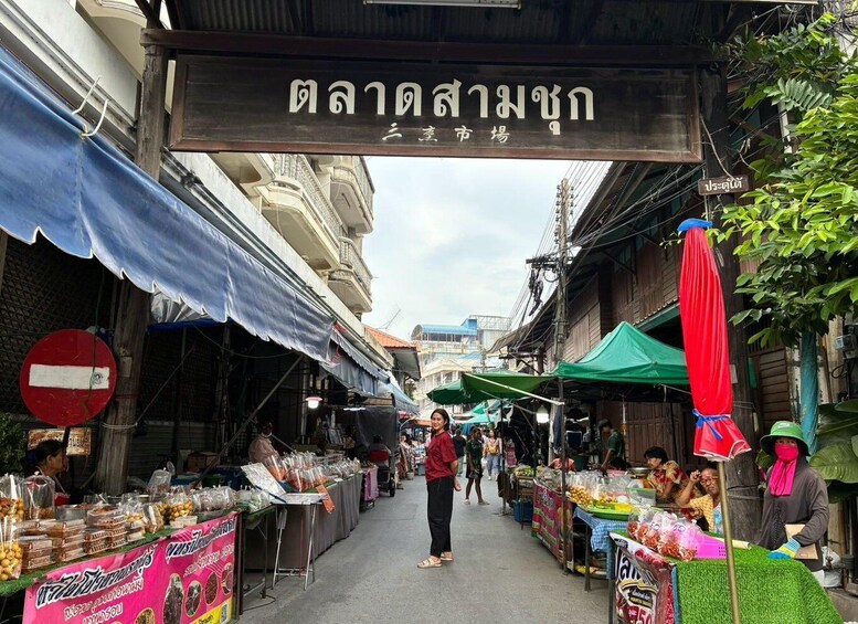 A bustling street market with vendors and shoppers. 2