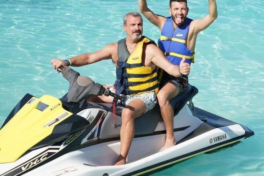 Two people on a jet ski in a body of water. 2