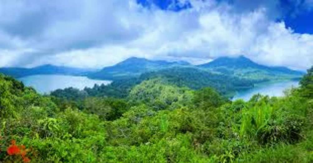 A mountainous landscape with a lake and dense greenery. 5