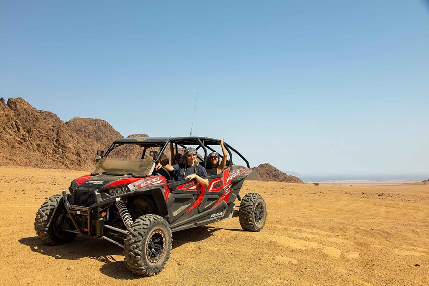 A Polaris off-road vehicle in a desert landscape. 3