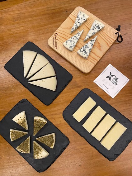 Various cheeses on black and wooden boards. 4