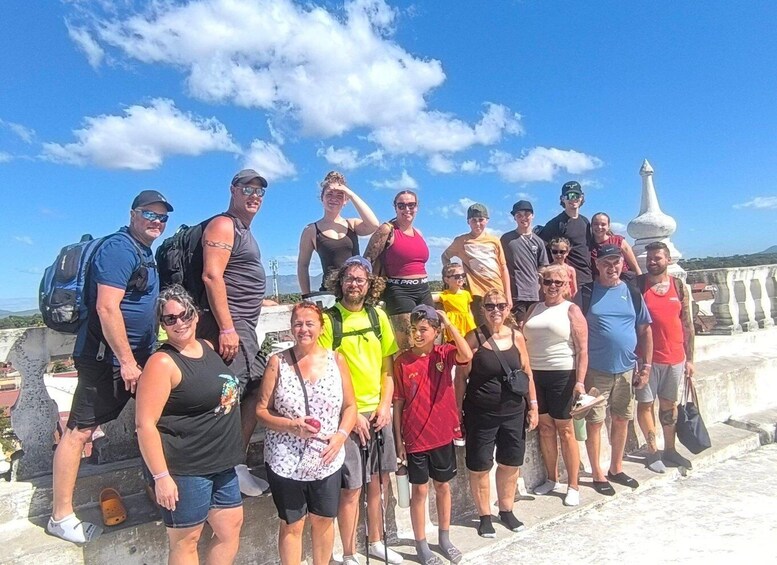 A group of people standing on a stone bridge with a clear sky. 5