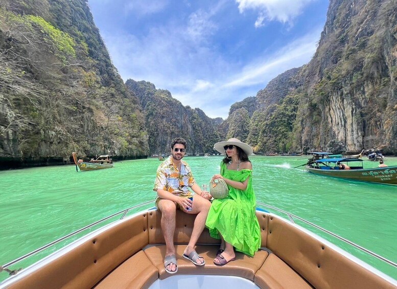 A couple on a boat in a narrow waterway surrounded by steep cliffs. 3