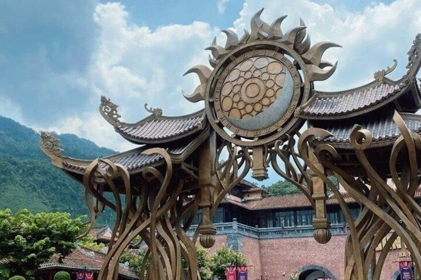 Ornate gate with traditional architecture and mountainous backdrop. 4